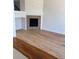 Open concept living room featuring a tile fireplace, hardwood floors, and natural light at 12317 W Gould Ave, Littleton, CO 80127