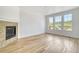 Bright living room features hardwood floors, modern fireplace, and three large windows offering natural light at 12317 W Gould Ave, Littleton, CO 80127