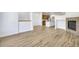 Open floor plan with hardwood floors and fireplace leading into the kitchen area at 12317 W Gould Ave, Littleton, CO 80127