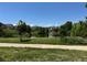 Scenic view of community pond surrounded by lush greenery and homes at 12317 W Gould Ave, Littleton, CO 80127