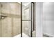 Modern shower with tile surround, glass doors and bright lighting at 12317 W Gould Ave, Littleton, CO 80127