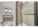 Modern shower with tile surround and glass doors, plus soaking tub and double vanity with granite at 12317 W Gould Ave, Littleton, CO 80127