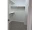 Bright walk-in closet featuring neutral carpet and built-in shelving for optimal organization at 12317 W Gould Ave, Littleton, CO 80127
