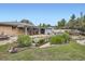 Expansive backyard featuring a pond, covered patio, and well-maintained landscaping at 6761 Harlan St, Arvada, CO 80003