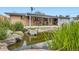 Picturesque backyard pond surrounded by rocks and greenery, offering a tranquil view at 6761 Harlan St, Arvada, CO 80003