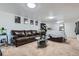 Spacious basement living area featuring plush carpet, comfortable seating, and entertainment space at 6761 Harlan St, Arvada, CO 80003