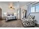 Comfortable bedroom with a large window, plush carpet, and a cozy armchair, ideal for relaxation at 6761 Harlan St, Arvada, CO 80003