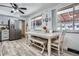 Bright dining area with a stylish table, stainless steel fridge, and hardwood floors, perfect for Gathering meals at 6761 Harlan St, Arvada, CO 80003