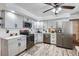 Modern kitchen with gray cabinets, stainless steel appliances, and countertops, creating a functional and stylish space at 6761 Harlan St, Arvada, CO 80003