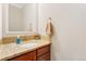 Powder room featuring a granite countertop, decorative mirror, and neutral color scheme at 8851 E 33Rd Ave, Denver, CO 80238
