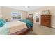 Cozy bedroom featuring a comfortable bed, ample natural light, and coordinated wooden furniture at 8851 E 33Rd Ave, Denver, CO 80238
