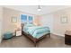 Comfortable bedroom featuring a window with blinds, carpet flooring, and an ensuite bath at 8851 E 33Rd Ave, Denver, CO 80238