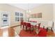 Dining room filled with natural light, featuring a modern table with red chairs and stylish decor at 8851 E 33Rd Ave, Denver, CO 80238