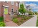 Brick townhome with a well-maintained yard and green door at 8851 E 33Rd Ave, Denver, CO 80238