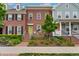 Brick townhome featuring a vibrant green door and landscaped front yard at 8851 E 33Rd Ave, Denver, CO 80238