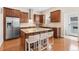 Gourmet kitchen featuring a center island, stainless appliances, and custom cabinets at 8851 E 33Rd Ave, Denver, CO 80238