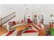 Open-concept living room with hardwood floors and staircase at 8851 E 33Rd Ave, Denver, CO 80238
