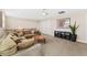 Cozy living area with comfortable seating, a ceiling fan, and a decorative area rug at 8851 E 33Rd Ave, Denver, CO 80238
