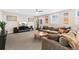 Spacious living room featuring plush seating, a ceiling fan, and a large TV at 8851 E 33Rd Ave, Denver, CO 80238