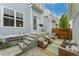 Cozy outdoor patio with modern seating, colorful rug, and access to the home's entrance at 8851 E 33Rd Ave, Denver, CO 80238