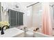 Bright bathroom featuring a shower-tub combo with a stylish vanity and a window at 1024 E 14Th Ave # 9, Denver, CO 80218