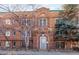 Charming brick building with an arched entryway and stone accents and a light gray front door at 1024 E 14Th Ave # 9, Denver, CO 80218