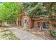 Charming brick building exterior entrance with stone detailing and mature landscaping at 1024 E 14Th Ave # 9, Denver, CO 80218