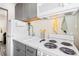 Bright kitchen featuring grey cabinets, a white countertop, and white appliances in a cozy space at 1024 E 14Th Ave # 9, Denver, CO 80218