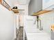 Galley kitchen showing sink, white appliances and view into hallway with wall decor at 1024 E 14Th Ave # 9, Denver, CO 80218