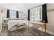 Comfortable bedroom features lots of natural light from windows and is furnished with a simple desk setup at 1024 E 14Th Ave # 9, Denver, CO 80218