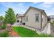 Backyard featuring a grassy lawn area, and covered patio with chairs and table at 9157 Rio Lado St, Littleton, CO 80125