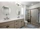Modern bathroom with double sinks and a glass-enclosed shower with seating at 9157 Rio Lado St, Littleton, CO 80125