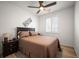 Cozy bedroom featuring neutral-colored walls, wood flooring, a bed with decorative pillows, and a ceiling fan at 9157 Rio Lado St, Littleton, CO 80125