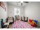 Bright Bedroom with playful decor, featuring a colorful rug, cribs, and toys at 9157 Rio Lado St, Littleton, CO 80125