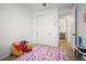 bedroom with a fuzzy colorful rug and a view into the bathroom at 9157 Rio Lado St, Littleton, CO 80125