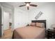Cozy bedroom with a ceiling fan, wood floors, and neutral-colored walls at 9157 Rio Lado St, Littleton, CO 80125