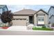 Charming single-story home featuring an attached two-car garage and low maintenance front yard at 9157 Rio Lado St, Littleton, CO 80125