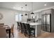 Modern kitchen with stainless steel appliances, kitchen island and bar stool seating at 9157 Rio Lado St, Littleton, CO 80125