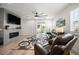 Bright living room with fireplace, ceiling fan and sliding doors to the backyard at 9157 Rio Lado St, Littleton, CO 80125