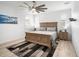 Bright bedroom with a wooden bed frame, carpeted floors, and large windows with shutters at 9157 Rio Lado St, Littleton, CO 80125