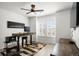 Bright home office featuring a ceiling fan, large window and adjustable height desk at 9157 Rio Lado St, Littleton, CO 80125