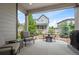 Relaxing covered patio with furniture overlooking the backyard at 9157 Rio Lado St, Littleton, CO 80125