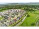Beautiful aerial view of a suburban neighborhood, green spaces, and a creek in a picturesque setting at 15061 W 70Th Ave, Arvada, CO 80007