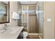 Modern bathroom with glass enclosed shower, stylish tile, and sleek vanity with granite countertop at 15061 W 70Th Ave, Arvada, CO 80007