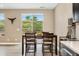 Charming dining area with views of the serene backyard, perfect for enjoying meals and creating lasting memories at 15061 W 70Th Ave, Arvada, CO 80007