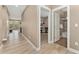 Inviting hallway leading to a well-appointed bathroom and a room with musical instruments, showcasing the home's layout at 15061 W 70Th Ave, Arvada, CO 80007