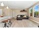 Inviting living area with large windows providing natural light, complete with a cozy leather sectional and modern decor at 15061 W 70Th Ave, Arvada, CO 80007