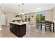 Open-concept living space featuring a stylish island and dining area, perfect for modern living and entertaining at 15061 W 70Th Ave, Arvada, CO 80007