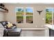 Comfortable living area showcasing a plush leather couch, bright windows, and modern decor for a welcoming ambiance at 15061 W 70Th Ave, Arvada, CO 80007