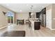 Bright, open living area with stainless appliances, an island with seating, and a view of the private patio at 15061 W 70Th Ave, Arvada, CO 80007